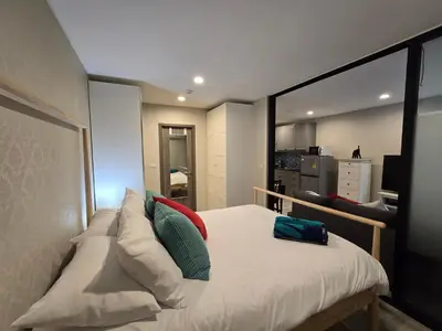 a bedroom with a bed with pillows on it at Pool Side Retreat 1 BED - TC-B105 in Phuket Town