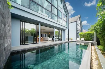 an external view of a house with a swimming pool at Designer Loft Villa Retreat in Pasak, Laguna Area in Ban Pak Lak