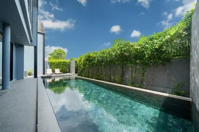 an infinity pool in a house with a fence at Designer Loft Villa Retreat in Pasak, Laguna Area in Ban Pak Lak