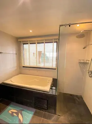a large bathroom with a tub and a shower at Bayshore 2 Bedroom Spacious Seaview Apartment in Patong Beach