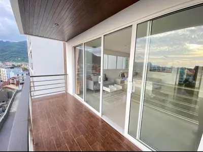 a balcony with a view of a living room at Bayshore 2 Bedroom Spacious Seaview Apartment in Patong Beach