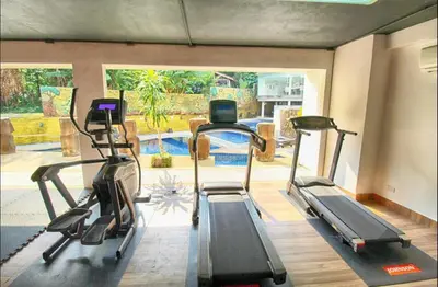 a gym with two treadmills in a room at Bayshore 2 Bedroom Spacious Seaview Apartment in Patong Beach