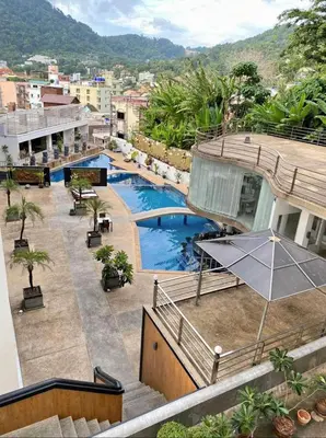 a view from the balcony of a hotel with a swimming pool at Bayshore 2 Bedroom Spacious Seaview Apartment in Patong Beach