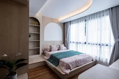 a bedroom with a bed and a large window at FantaSea condo Kamala 205 in Kamala Beach