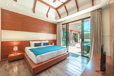 a bedroom with a bed and a sliding glass door at 3 Bedrooms villa walking distance to Rawai beach in Rawai Beach