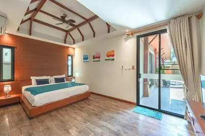 a bedroom with a bed and a sliding glass door at 3 Bedrooms villa walking distance to Rawai beach in Rawai Beach