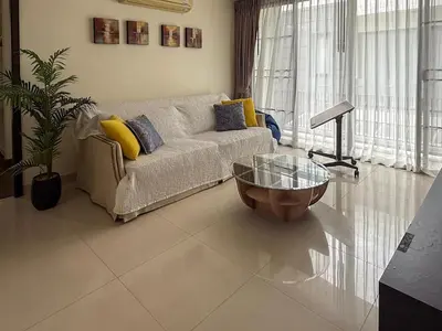 a living room with a couch and a glass table at Laguna Park Phuket 5BR Villa with Rooftop Pool #84194 in Laguna Phuket
