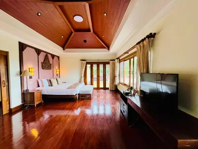 a bedroom with a bed and a flat screen tv at \u6574\u680b\u9ad8\u5962\u5eb7\u517b\u6cf3\u6c60\u522b\u5885 - \u5e26\u53a8\u5e08\u5973\u4f63 in Layan Beach