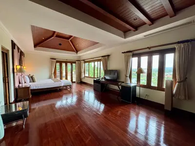 a large bedroom with a bed and a television in it at \u6574\u680b\u9ad8\u5962\u5eb7\u517b\u6cf3\u6c60\u522b\u5885 - \u5e26\u53a8\u5e08\u5973\u4f63 in Layan Beach