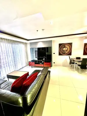 a living room with a leather couch and a television at L08 Penthouse Suite Modern Condo On Bangla Road in Patong Beach