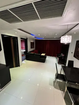 a living room with a couch and a table at L08 Penthouse Suite Modern Condo On Bangla Road in Patong Beach