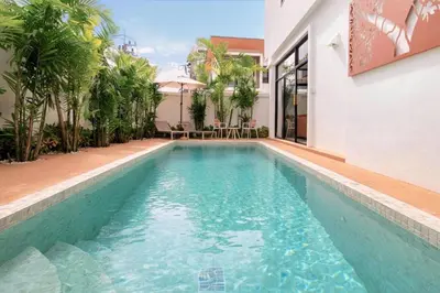 a swimming pool in the middle of a house at Goldena Residence Private Pool Villas in Kamala Beach