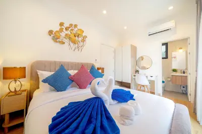 a bedroom with two swans sitting on a bed at Goldena Residence Private Pool Villas in Kamala Beach