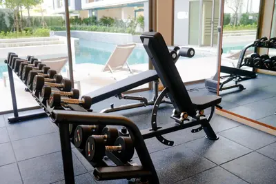 a row of exercise equipment in a gym at Ozone Sky View Residence in Laguna Phuket