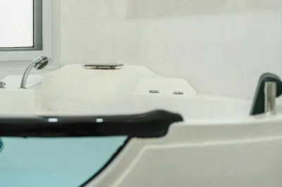 a bathroom with a white sink and a black faucet at Platinum Villa Rawai in Rawai Beach