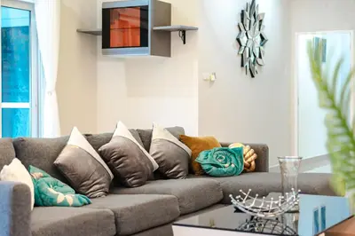 a living room with a couch with pillows on it at Platinum Villa Rawai in Rawai Beach