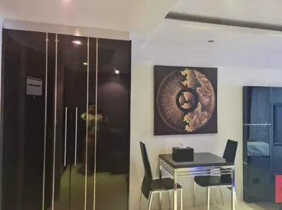 a dining room with a table and a painting on the wall at L01 Bangla Suites Modern Studio On Bangla Road in Patong Beach