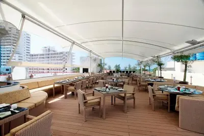 a restaurant with tables and chairs and a large window at L01 Bangla Suites Modern Studio On Bangla Road in Patong Beach