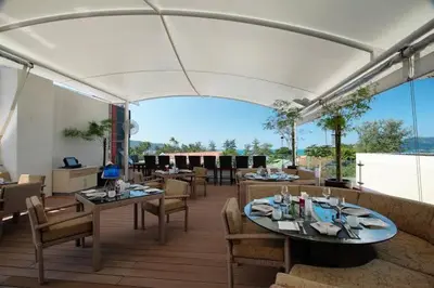 a restaurant with tables and chairs and a white canopy at L01 Bangla Suites Modern Studio On Bangla Road in Patong Beach