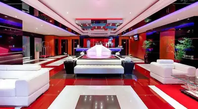 a living room with white furniture and a red floor at L01 Bangla Suites Modern Studio On Bangla Road in Patong Beach