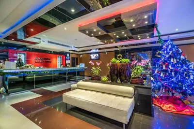 a lobby with a christmas tree and a white couch at L02 Bangla Suites Modern Studio On Bangla Road in Patong Beach