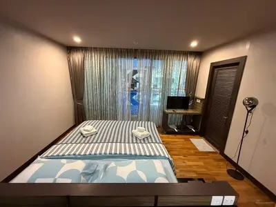 a small bedroom with a bed and a window at The Regent Bang Tao Beach in Phuket