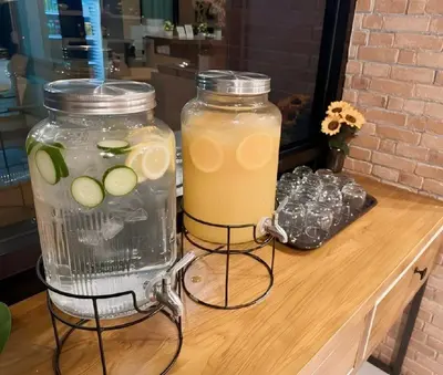 a blender and a drink on a wooden table at Phuket Five Fortune Holiday Hotel in Rawai Beach