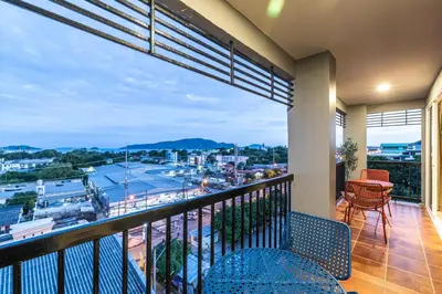 a balcony with a view of a city at Phuket Five Fortune Holiday Hotel in Rawai Beach