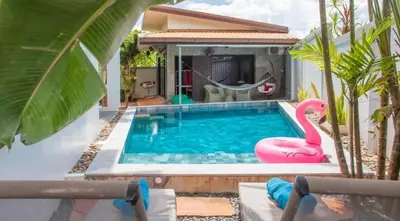 a swimming pool with a pink flamingo next to a house at 150 m from a paradise beach 3 bedrooms pool in Klong Muang Beach