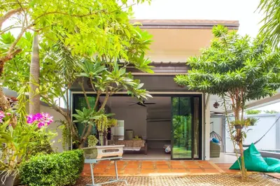 a house with a courtyard with trees at 150 m from a paradise beach 3 bedrooms pool in Klong Muang Beach