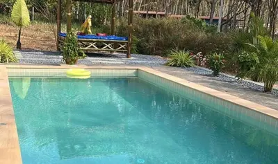 a swimming pool with a yellow frisbee in it at Baan ton mai 2 bedrooms 400 m from the beach in Klong Muang Beach
