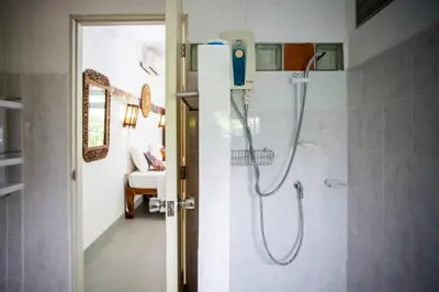 a shower in a bathroom with a glass door at Villa with private pool and mountain views in Ban Khlong Son