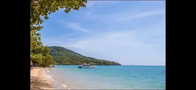 a boat in the water on a beach at Jaccuzi House 5 pl 200 m from a beautiful beach in Klong Muang Beach