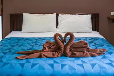 two swans made out of towels on a bed at House 4 people sea view 100 m from the beach in Klong Muang Beach