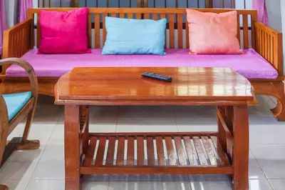 a remote control sitting on a table next to a couch at House 4 people sea view 100 m from the beach in Klong Muang Beach
