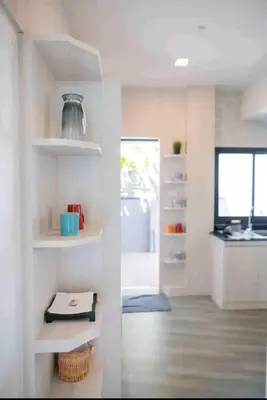 a kitchen with white shelves in a room at Pool Villa Suchada 2 bedrooms in Ban Khlong Haeng