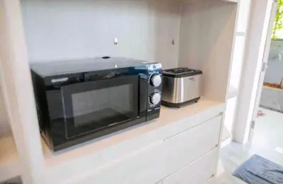 a microwave sitting on a counter in a kitchen at Pool Villa Suchada 2 bedrooms in Ban Khlong Haeng