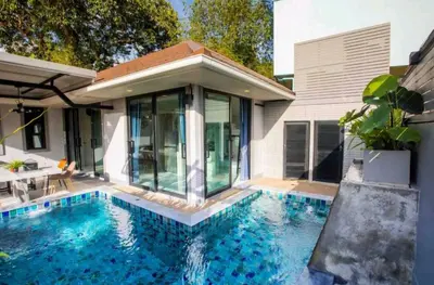 a swimming pool in front of a house at Pool Villa Suchada 2 bedrooms in Ban Khlong Haeng
