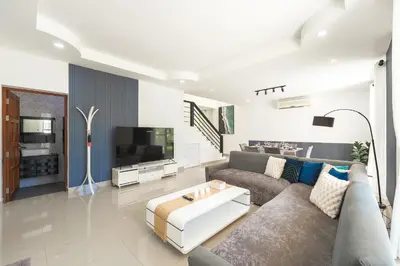 a living room with a couch and a tv at Platinum Villa 4 bedrooms Rawai in Rawai Beach