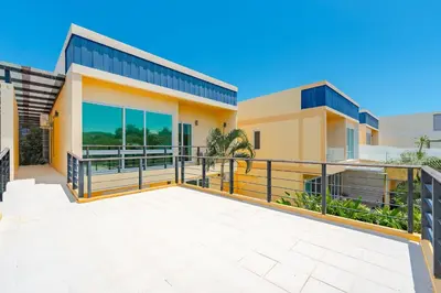 a house with a large balcony in front of it at Platinum Villa 4 bedrooms Rawai in Rawai Beach