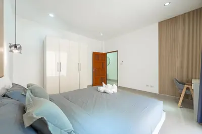 a bedroom with a bed with two stuffed animals on it at Platinum Villa 4 bedrooms Rawai in Rawai Beach