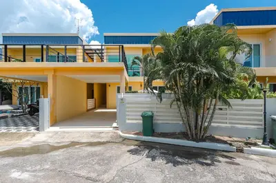 a house with a palm tree in front of it at Platinum Villa 4 bedrooms Rawai in Rawai Beach