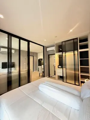 a bedroom with a large white bed and glass walls at Andaman 3 in Ban Thalat Choeng Thale
