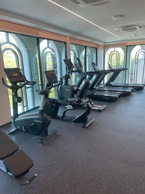 a gym with rows of exercise bikes and treadmills at Andaman 3 in Ban Thalat Choeng Thale