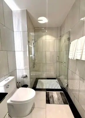 a white bathroom with a shower and a toilet at Andaman 3 in Ban Thalat Choeng Thale