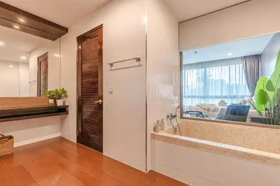 a bathroom with a large mirror and a sink at Majestic 2BR Residence with garden view in Regent in Bang Tao Beach