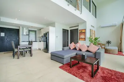 a living room with a couch and a table at Raya Villa 2 Bed Beachfront Villa Private Pool in Rawai Beach