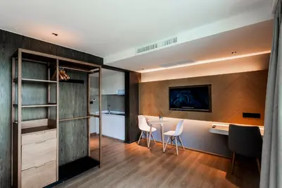 a kitchen and dining room with a table and chairs at La Vita Phuket by Beringela in Rawai Beach