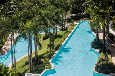 an aerial view of a resort pool with palm trees at La Vita Phuket by Beringela in Rawai Beach