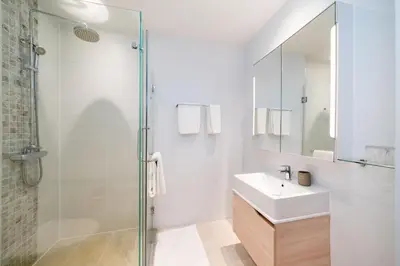 a bathroom with a sink and a glass shower at Diamond Bangtao Beach 1 bedroom in Bang Tao Beach